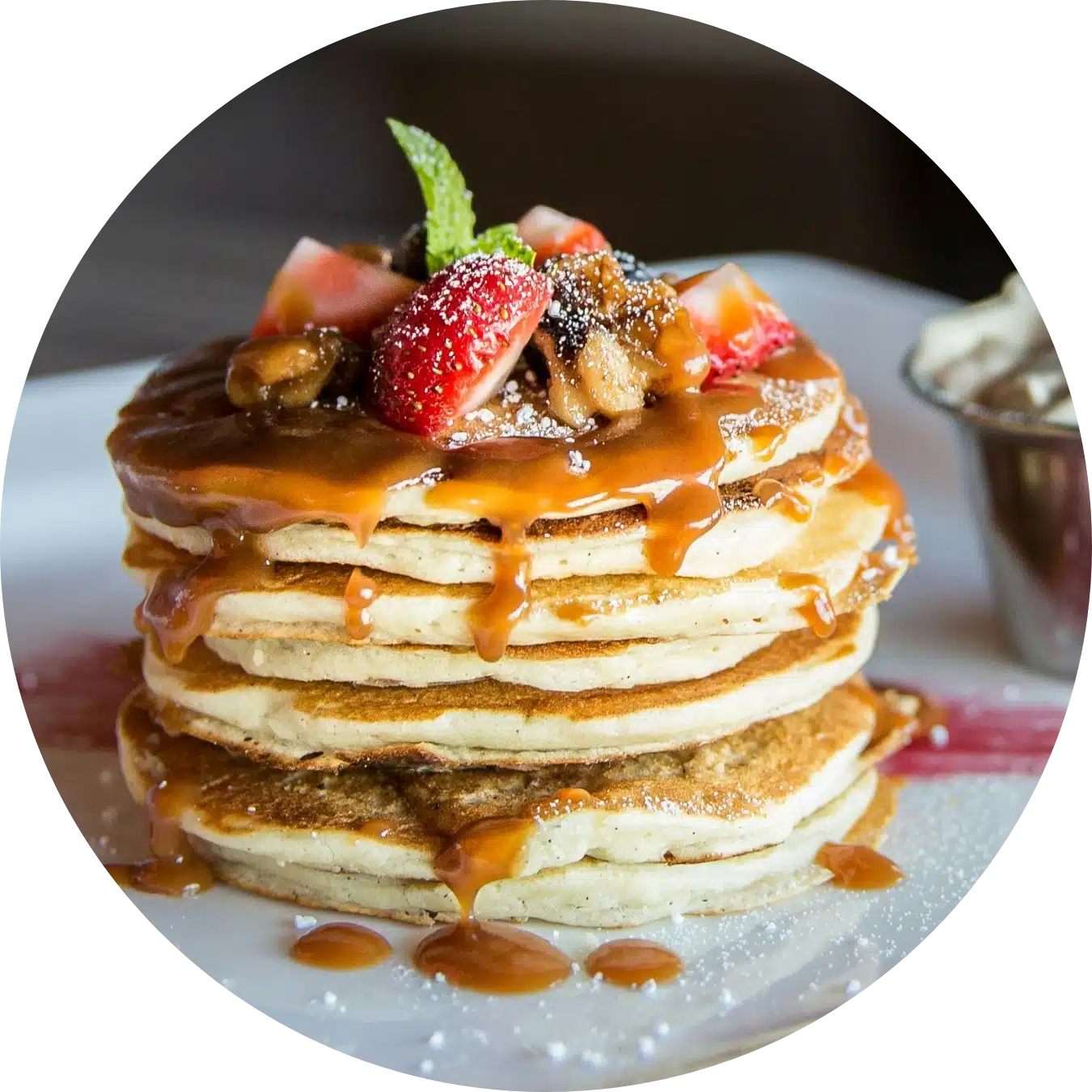 Fluffy pancake stack with caramel sauce and fresh strawberries