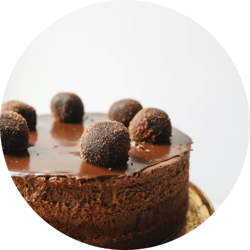 Decadent chocolate mousse cake topped with truffle balls