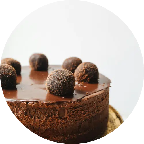 Decadent chocolate mousse cake topped with truffle balls