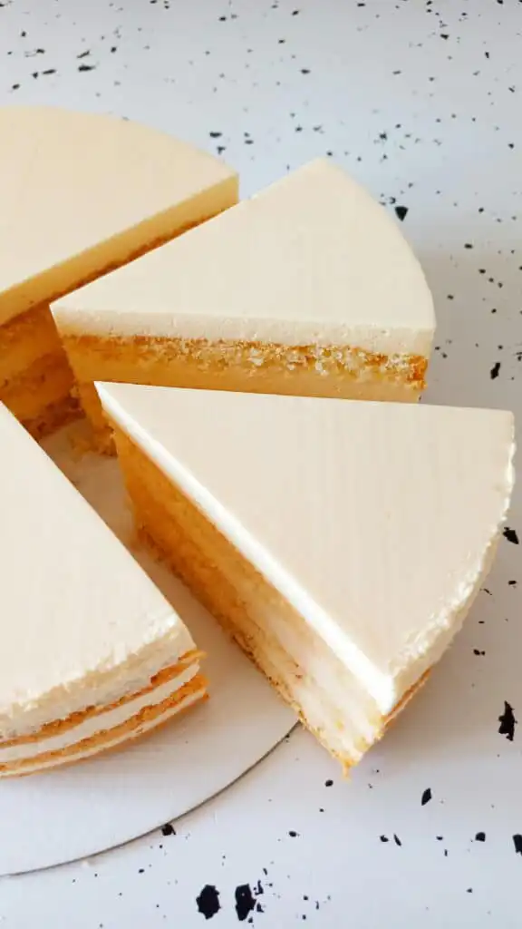 Slice of cake orange creamsicle on a plate with frosting