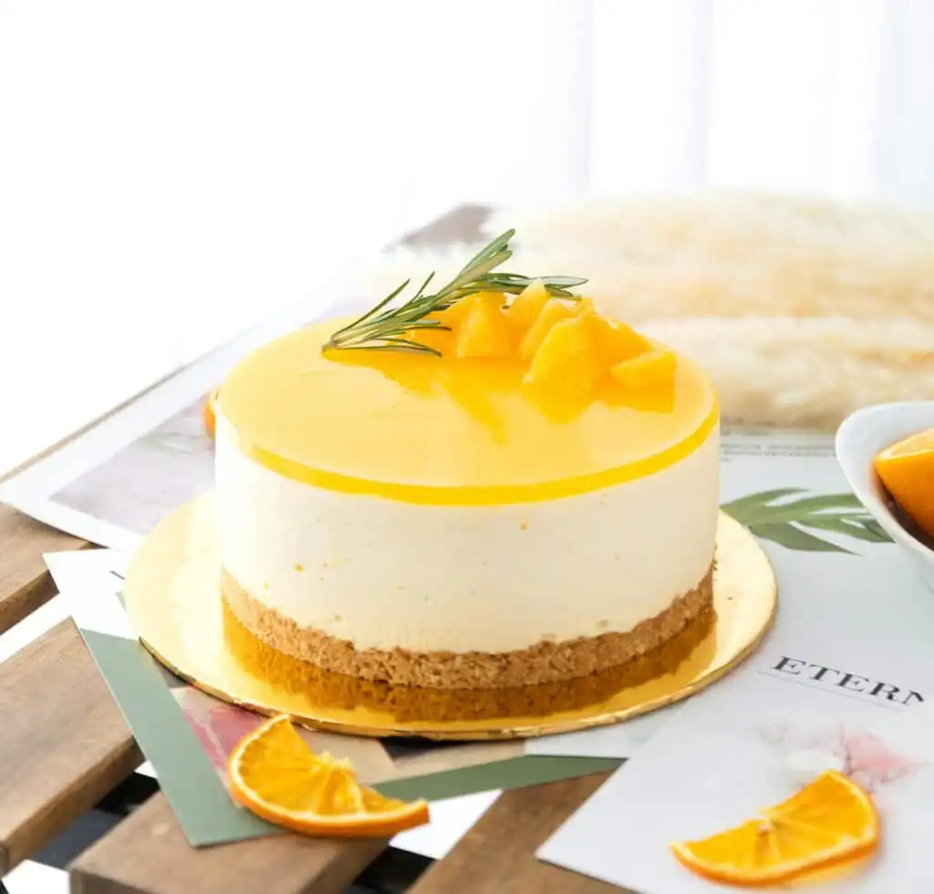 Batter for cake orange creamsicle being poured into pans
