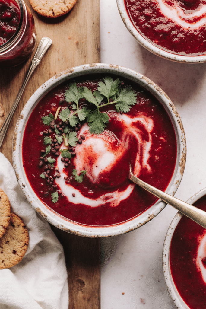 A grouping of fresh, deep purple whole beetroots, accompanied by spices, high-pectin apples, and acidifiers (lemons), representing the full ingredient list.