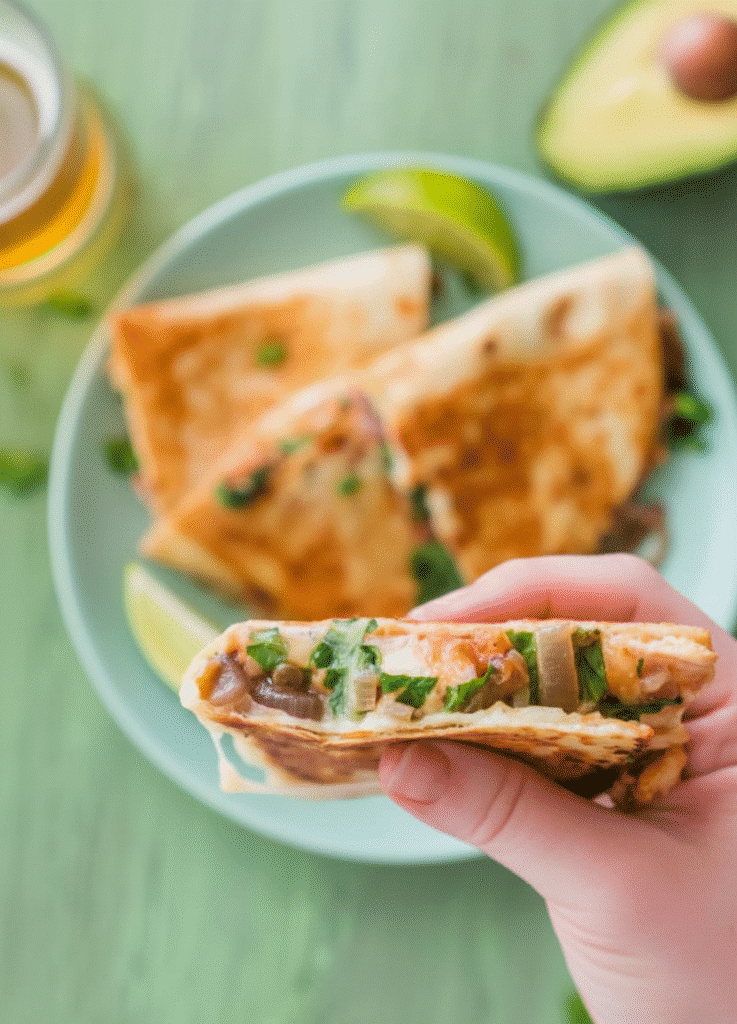 Delicious BBQ Chicken Quesadillas served with salsa and garnished with herbs