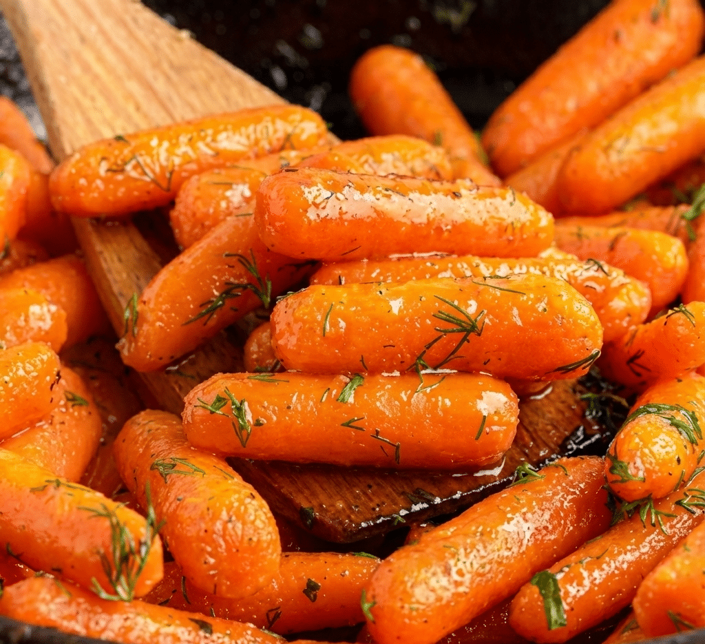 A white serving dish filled with easy glazed carrots topped with fresh parsley and a honey butter glaze. recipe card