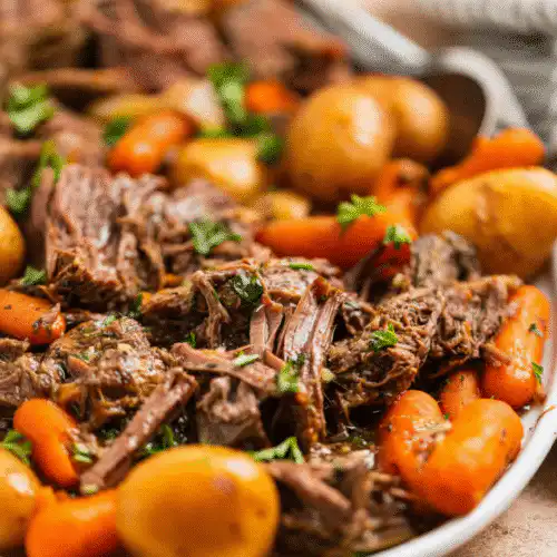 Delicious French onion pot roast served with herbs and a side of vegetables. recipe card