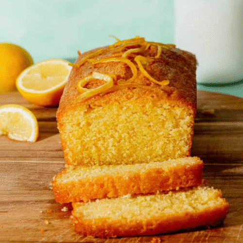 Deliciously moist lemon cake decorated with fresh lemon slices and icing recipe card