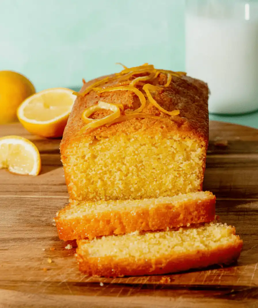 Deliciously moist lemon cake decorated with fresh lemon slices and icing recipe card