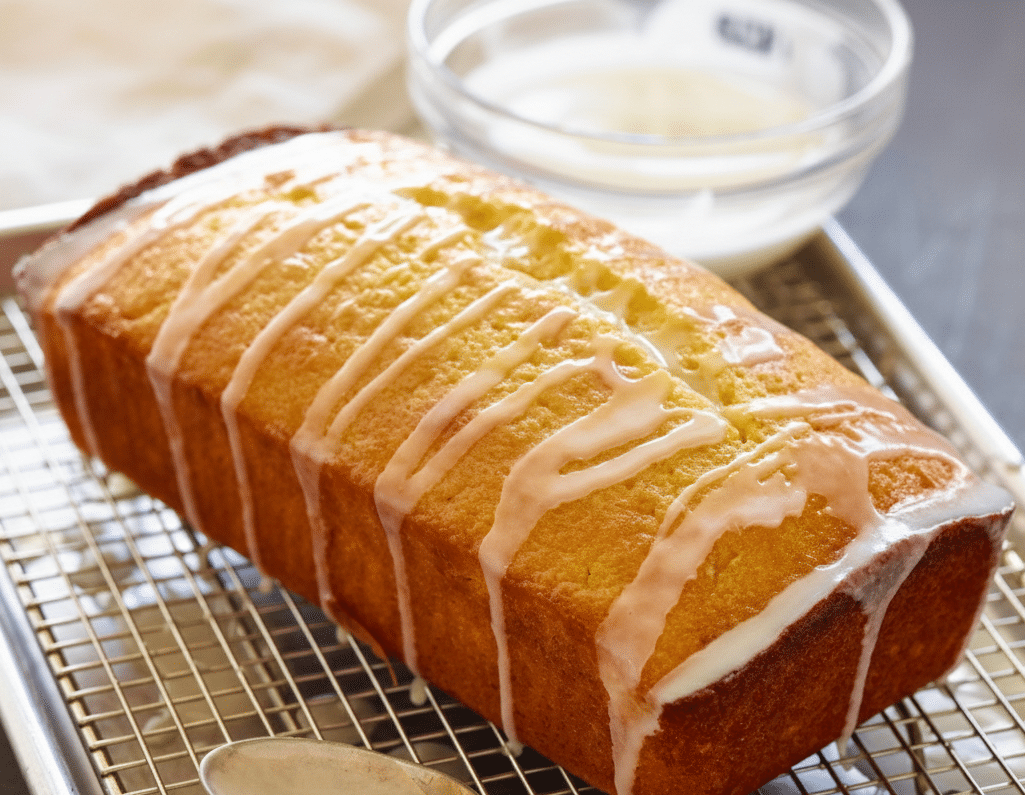 Deliciously moist lemon cake decorated with fresh lemon slices and icing