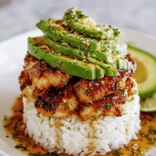 Stack of honey lime chicken, avocado, and rice topped with cilantro and a lime wedge. recipe card