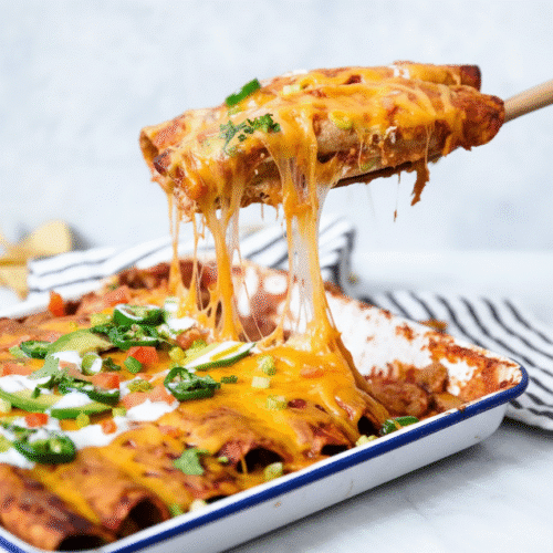 Easy chicken enchiladas topped with cheese and served on a plate recipe card