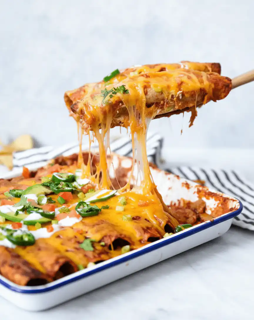 Easy chicken enchiladas topped with cheese and served on a plate recipe card
