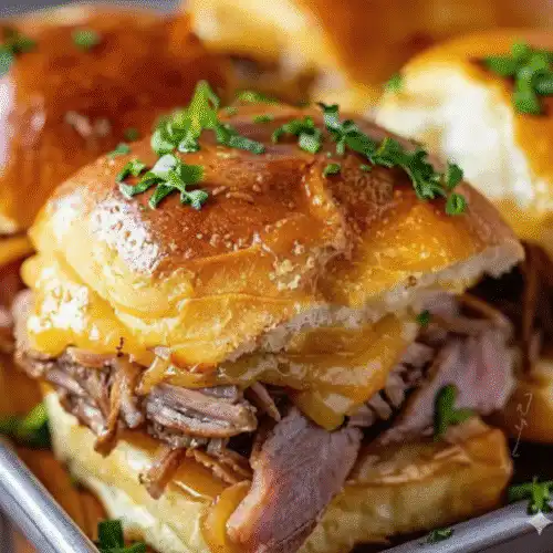 Savory French Dip sliders served on a platter with au jus for dipping. recipe card