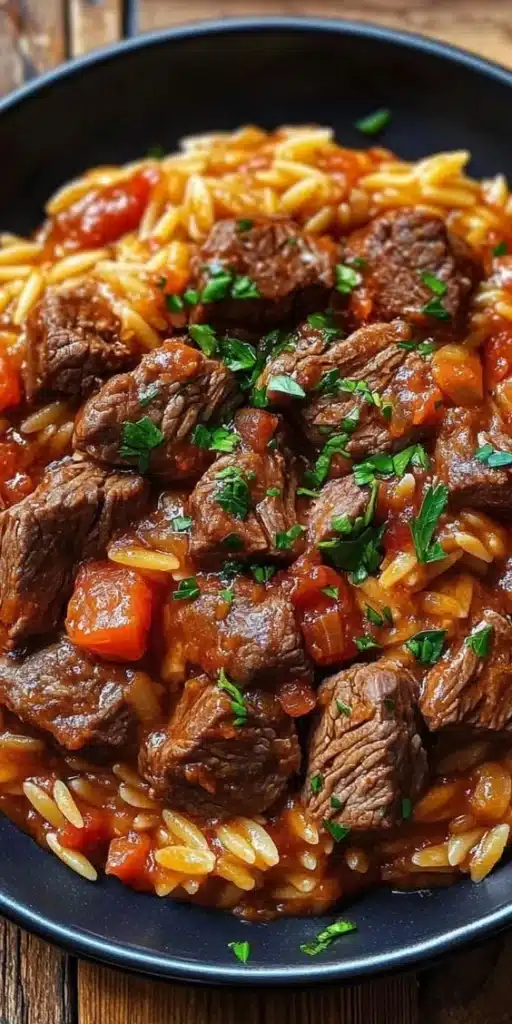 Delicious Beef Giouvetsi with tender beef and orzo pasta served in a rustic dish.