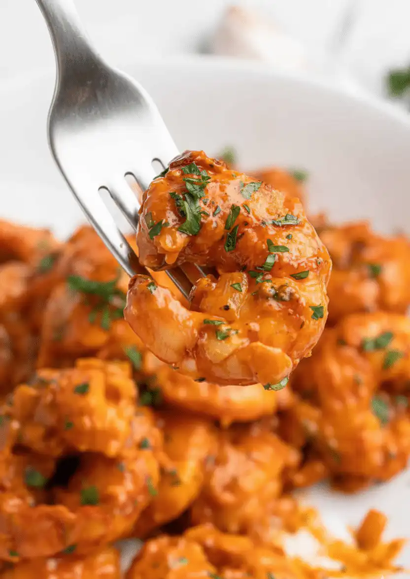 A top-down view of a Creamy Tuscan Shrimp Recipe featuring succulent shrimp, sun-dried tomatoes, and spinach in a rich garlic cream sauce. recipe card