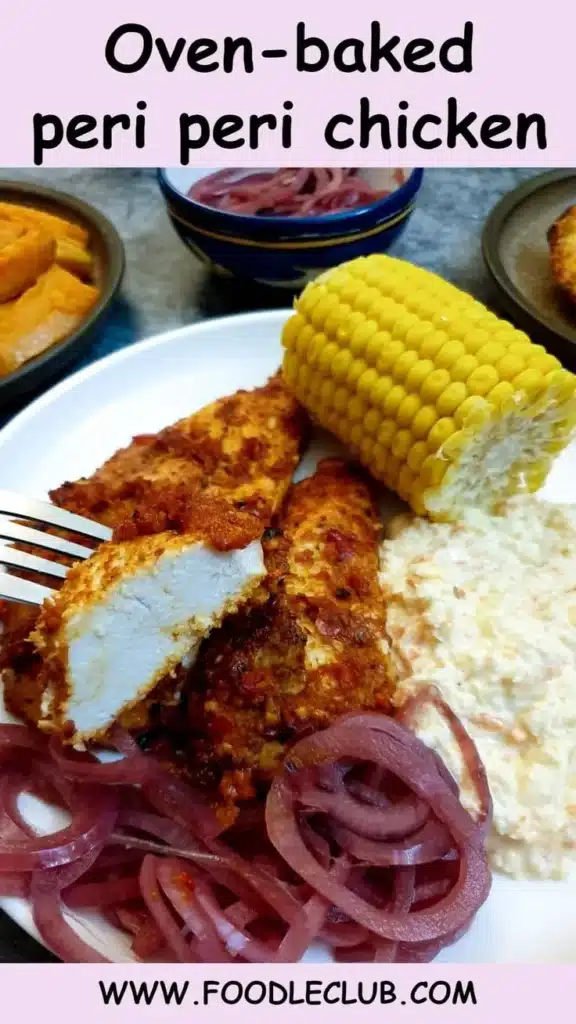 A mouthwatering plate of oven-baked peri peri chicken garnished with herbs