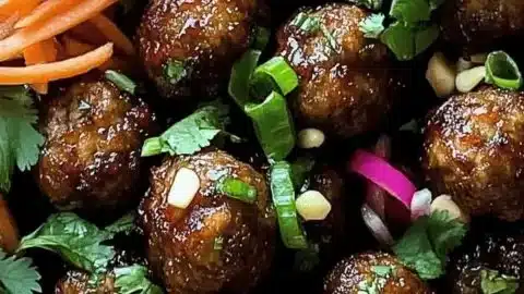 Banh Mi Meatballs appetizer served on a platter with fresh herbs and sauces