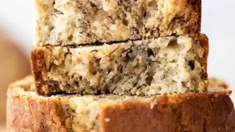 homemade banana bread fresh out of the oven on a wooden cutting board