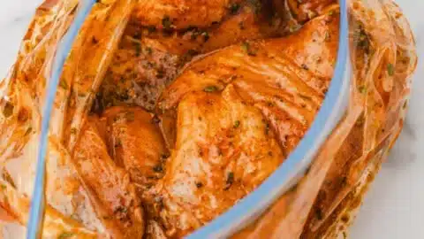 Easy Mexican Chicken Marinade 2 Juicy Mexican chicken marinated with spices and herbs in a bowl.