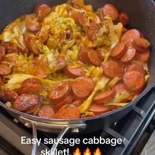 Easy sausage cabbage skillet dish with colorful vegetables in a frying pan