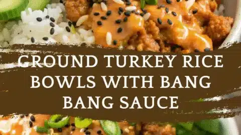 Ground turkey rice bowls topped with bang bang sauce on a colorful plate.