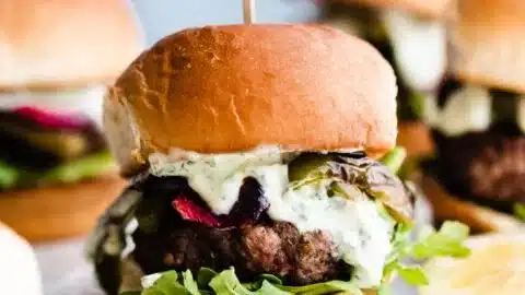 Lamb Sliders with Herby Yogurt Sauce and Roasted Peppers 2 Lamb sliders with herby yogurt sauce and roasted peppers on a plate