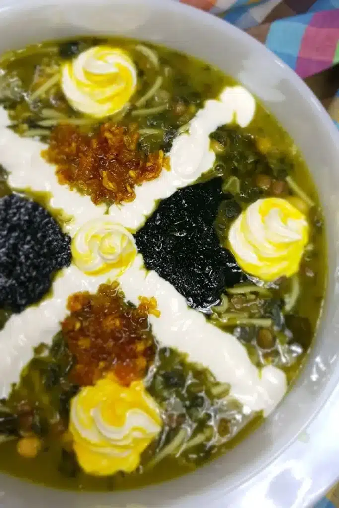 Delicious noodle soup with legumes and fresh greens served in a bowl