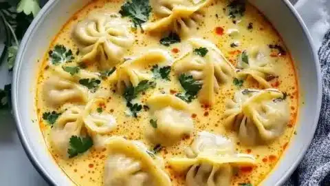 Bowl of Thai Coconut Curry Dumpling Soup showcasing vibrant colors and ingredients