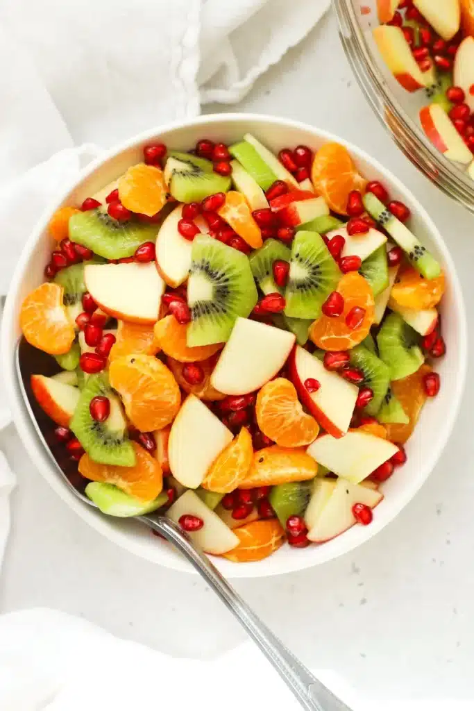 A colorful winter fruit salad drizzled with fresh citrus dressing.