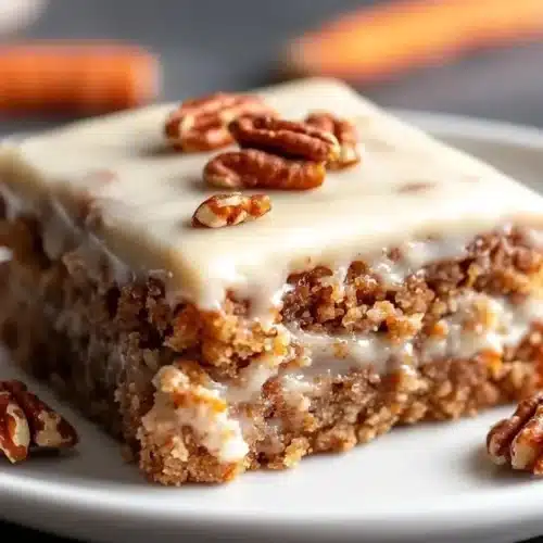 Carrot Cake Oatmeal Bake 2 Carrot Cake Oatmeal Bake served in a dish with frosting and garnished with nuts
