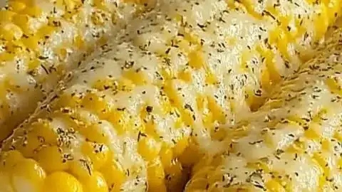 Delicious Garlic Parmesan Corn on the cob served with garnish