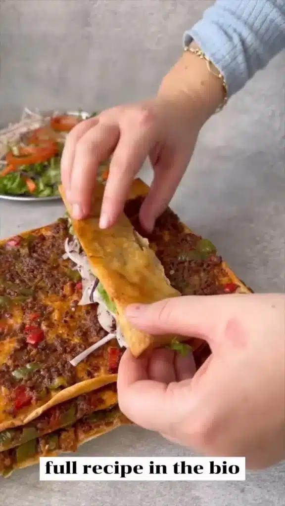 Turkish Lahmacun topped with spiced meat and fresh herbs on a flatbread.