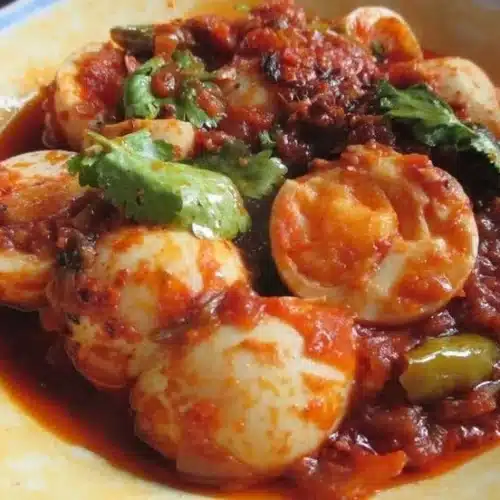 Delicious Burmese Egg Curry served with rice and garnished with herbs