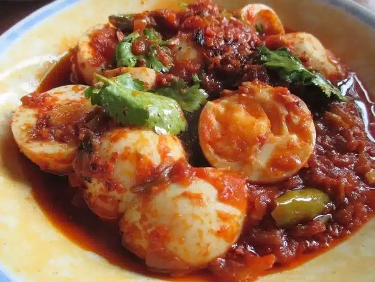 Delicious Burmese Egg Curry served with rice and garnished with herbs