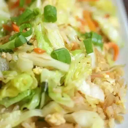 Bowl of colorful cabbage fried rice with vegetables and herbs