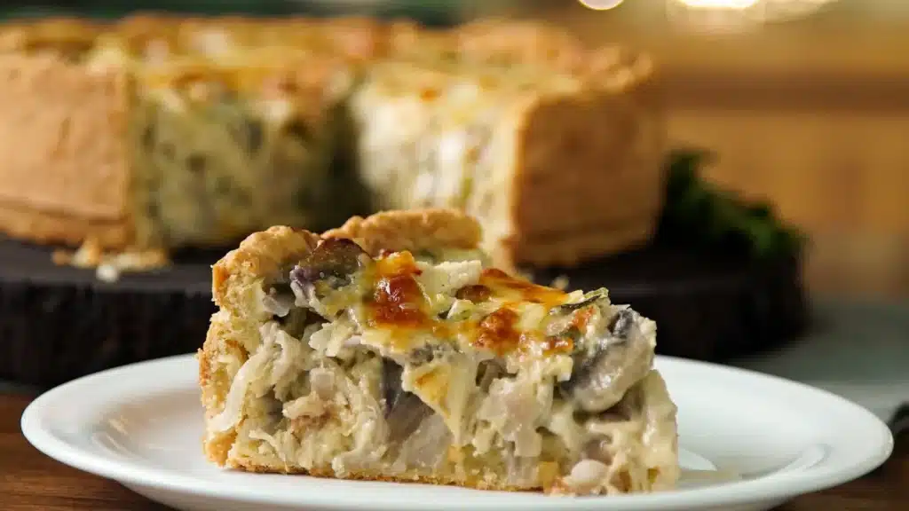 Caramelized onion mushroom chicken tart on a wooden serving board