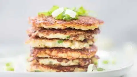 Golden Cauliflower Hash Browns on a plate, crispy and healthy breakfast option