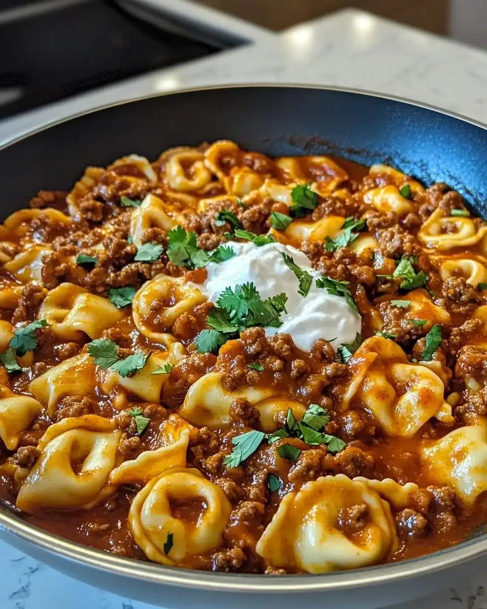 Creamy Cheesy Beef Enchilada Tortellini served in a bowl with melted cheese