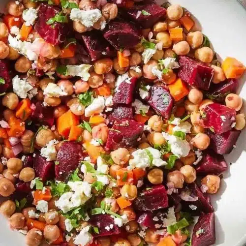 Chickpea, Beet & Feta Salad 2 Chickpea, Beet, and Feta Salad in a bowl garnished with fresh herbs