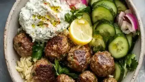 Delicious Gyro Bowls with Meatballs, Tzatziki & Lemon Rice 2 Delicious gyro bowl featuring meatballs, tzatziki sauce, and lemon rice.