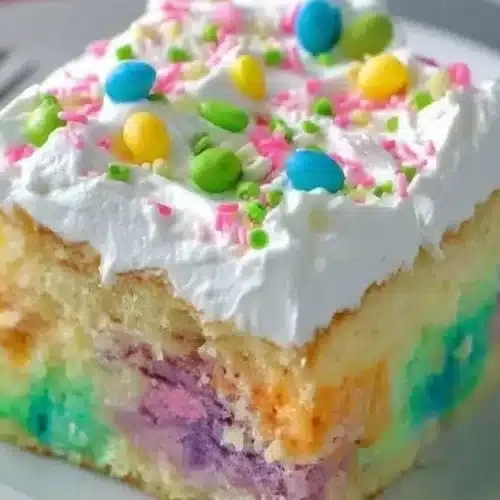 Easy Easter Poke Cake decorated with pastel colors and Easter-themed toppings