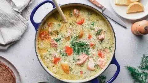 Finnish Salmon Soup (Lohikeitto) 2 Bowl of Finnish Salmon Soup (Lohikeitto) with fresh ingredients and herbs
