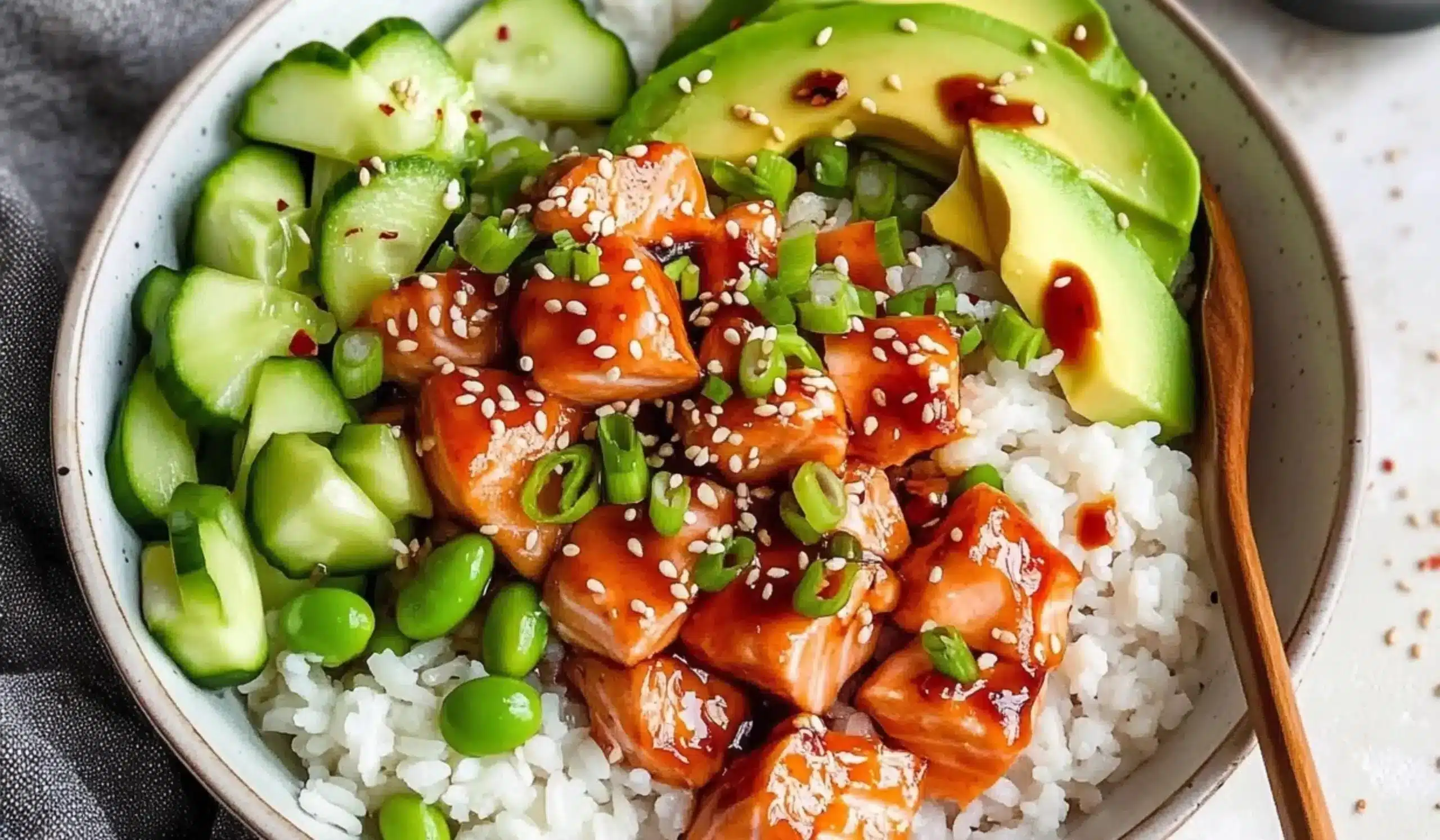 Delicious Honey Sriracha Salmon Bowl with fresh vegetables and rice