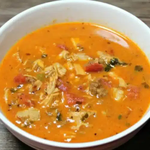 Bowl of Keto Chicken Chorizo Soup garnished with fresh herbs