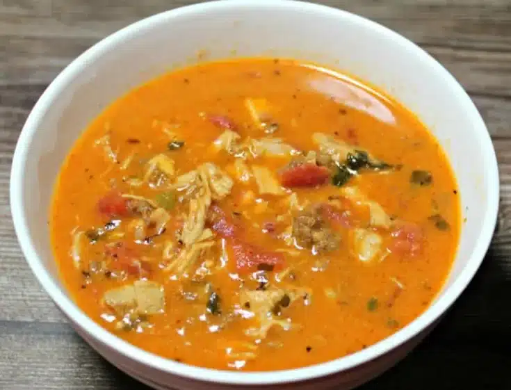 Bowl of Keto Chicken Chorizo Soup garnished with fresh herbs