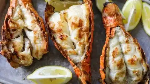 Perfectly Grilled Lobster Tail Recipe 2 Perfectly grilled lobster tail served on a plate with lemon garnish