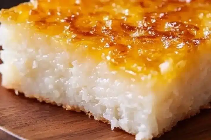 Deliciously moist Sticky Coconut Cake (Wingko Babat) served on a plate.