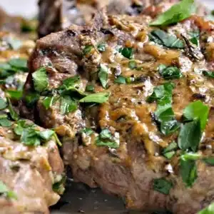 Delicious easy oven-roasted lamb chops garnished with herbs