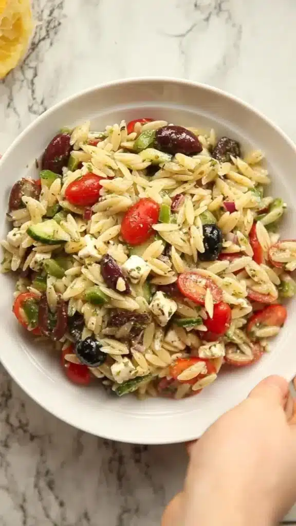 Delicious Greek Orzo Salad with fresh vegetables and herbs