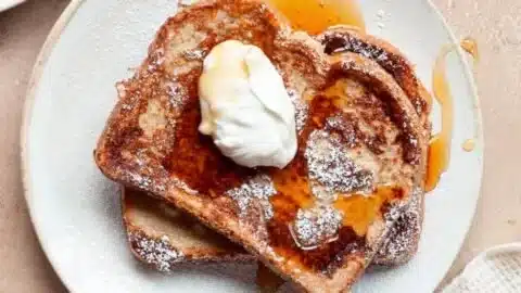 Delicious high protein French toast topped with fresh berries and maple syrup