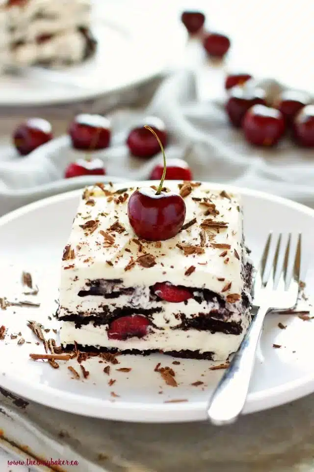 No Bake Black Forest Icebox Cake topped with cherries and whipped cream.